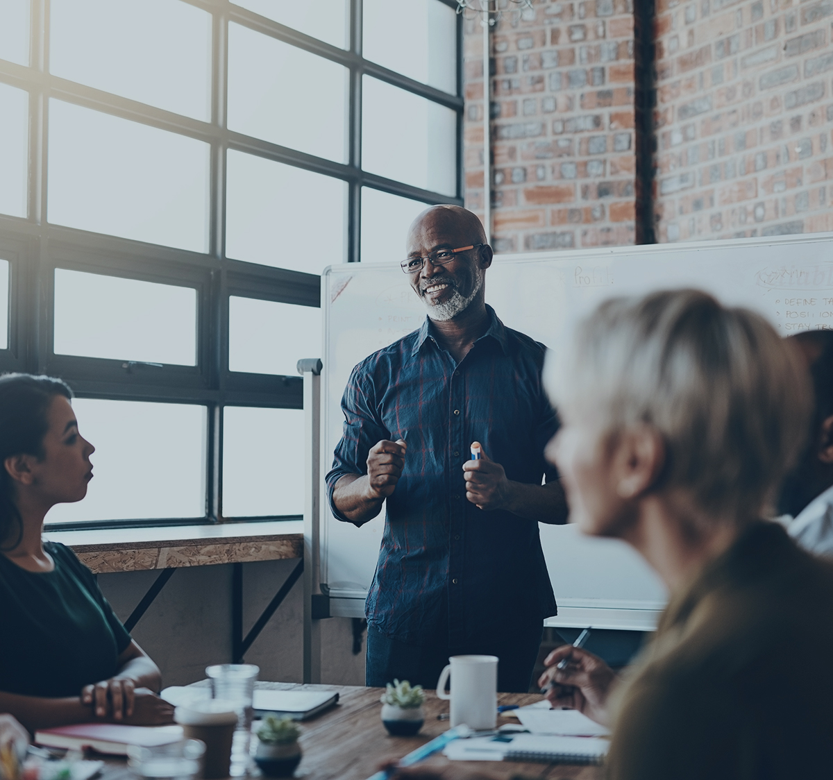 Man speaking to production company team in meeting